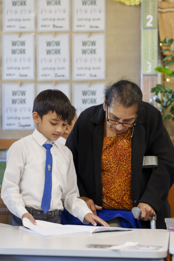 Old Indian lady helping boy with his schoolwork