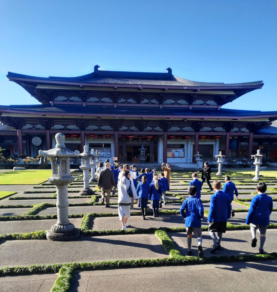 Group walking towards Chinese temple.