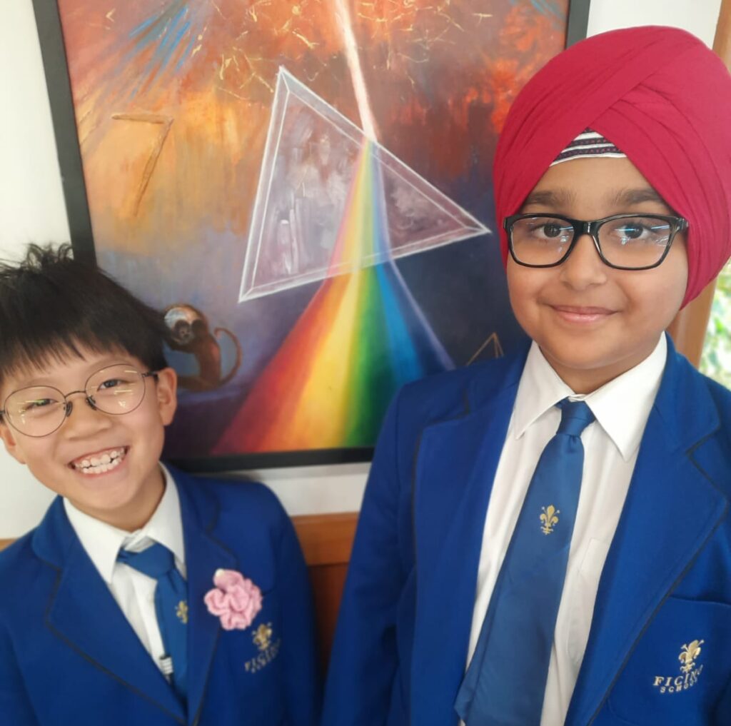 Two boys one wearing a pink turban