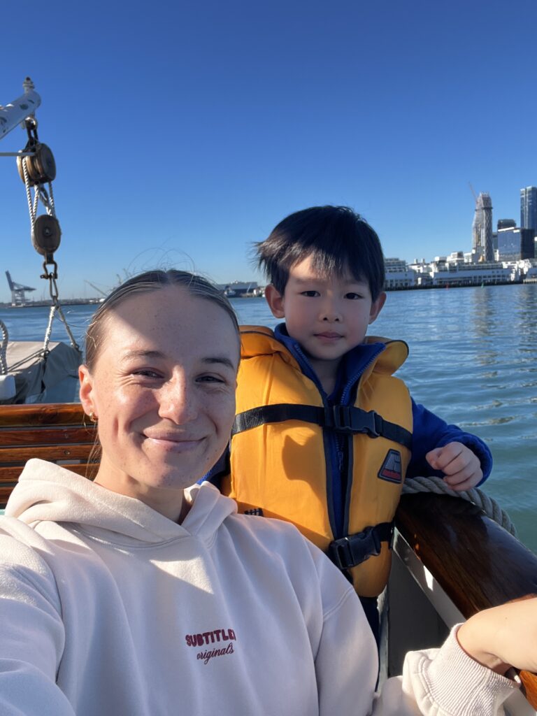A European woman and a young chinese boy on a boaty