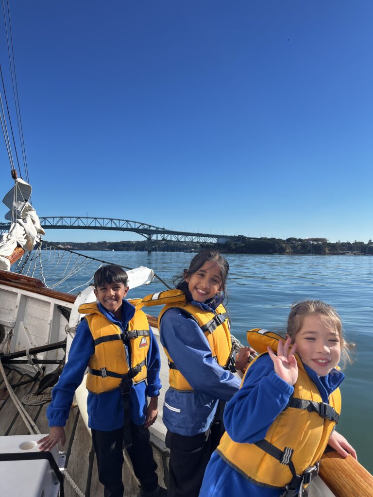 A group of children wearing lifejackets on a boat