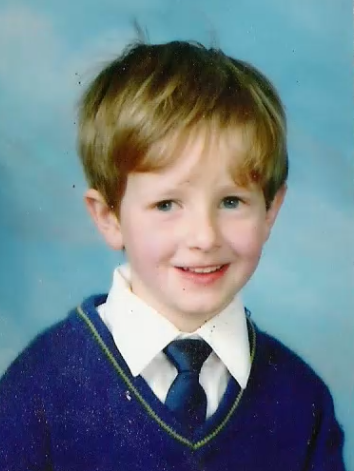 young blonde boy in school uniform