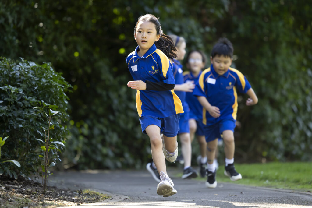 A group of school children running a race